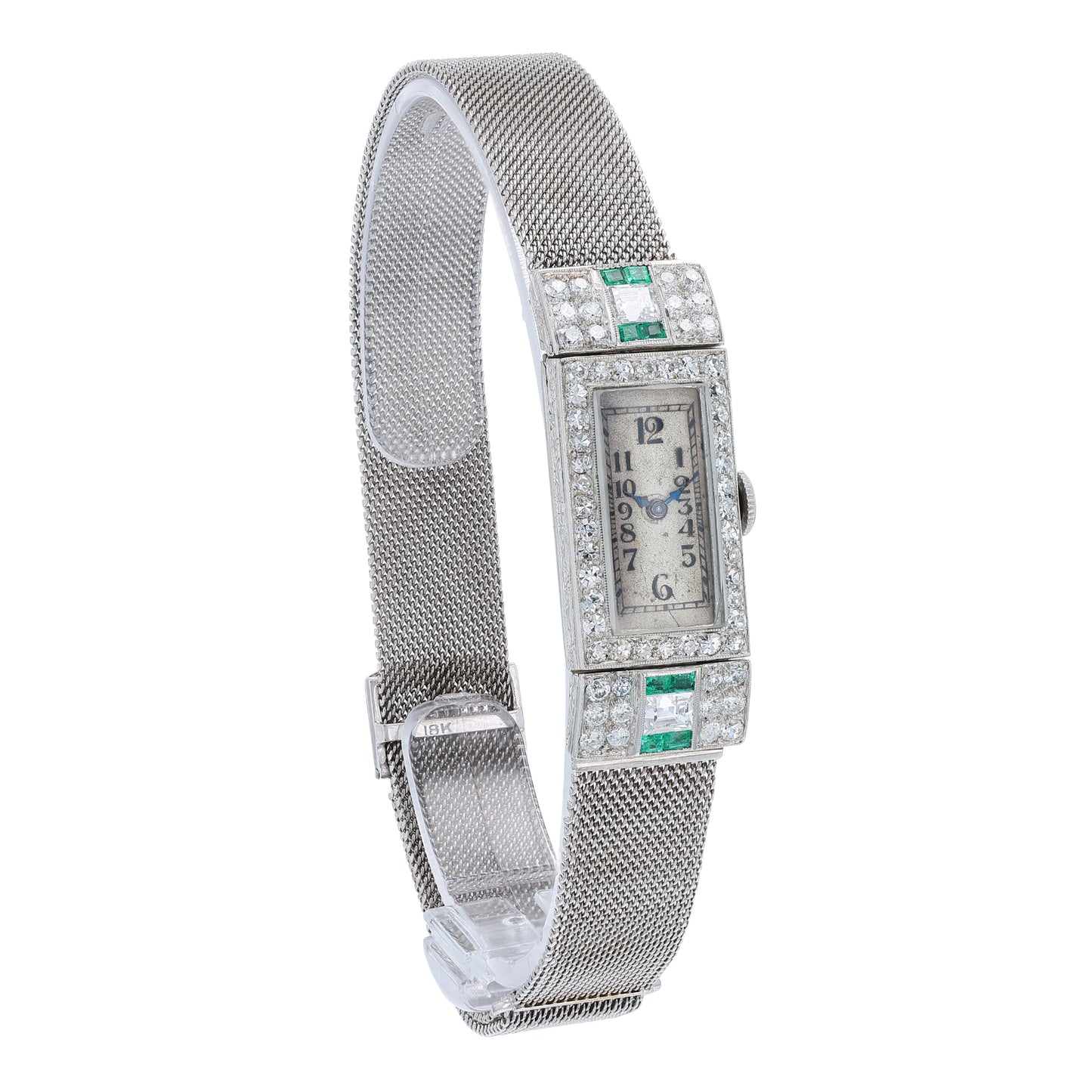 Estate platinum and white gold watch with diamond and emerald accents on case front with an off white dial on a white background