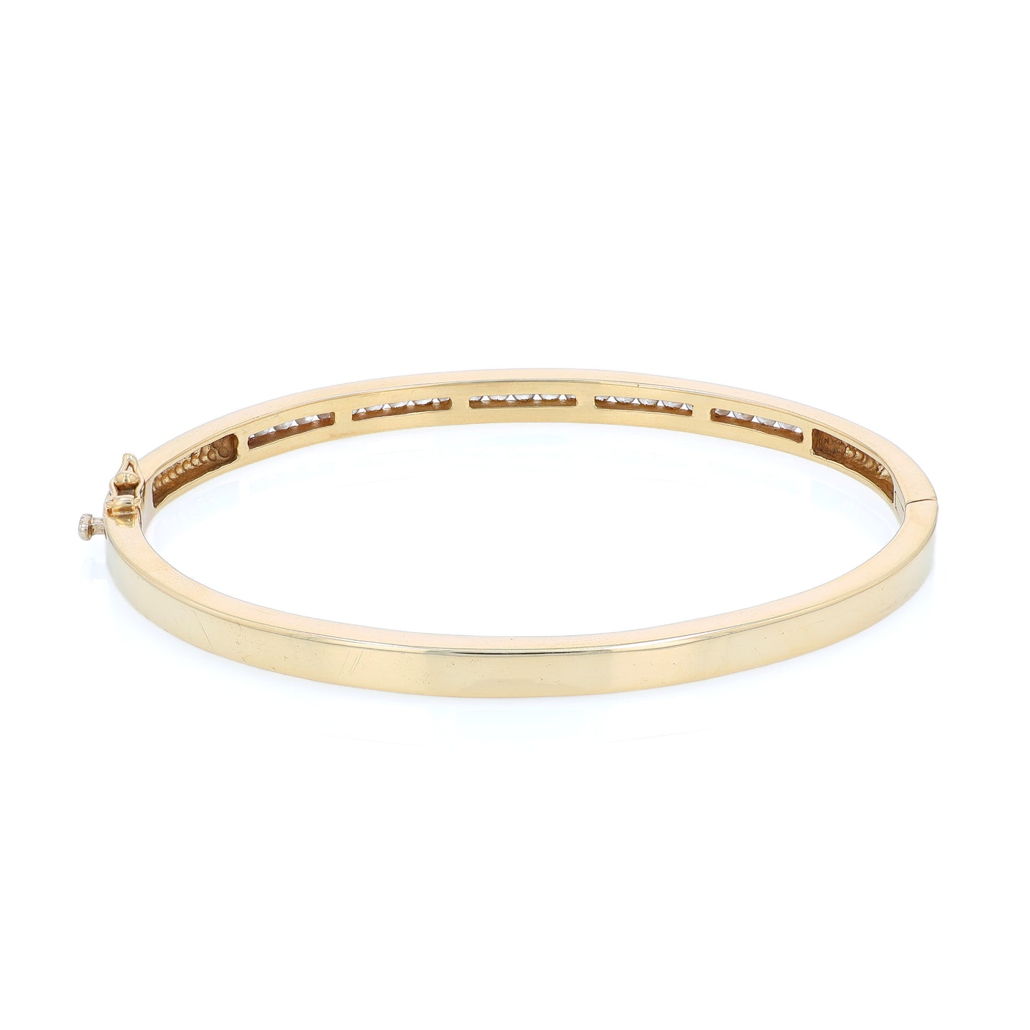 Yellow gold channel set diamond bangle bracelet on a white background