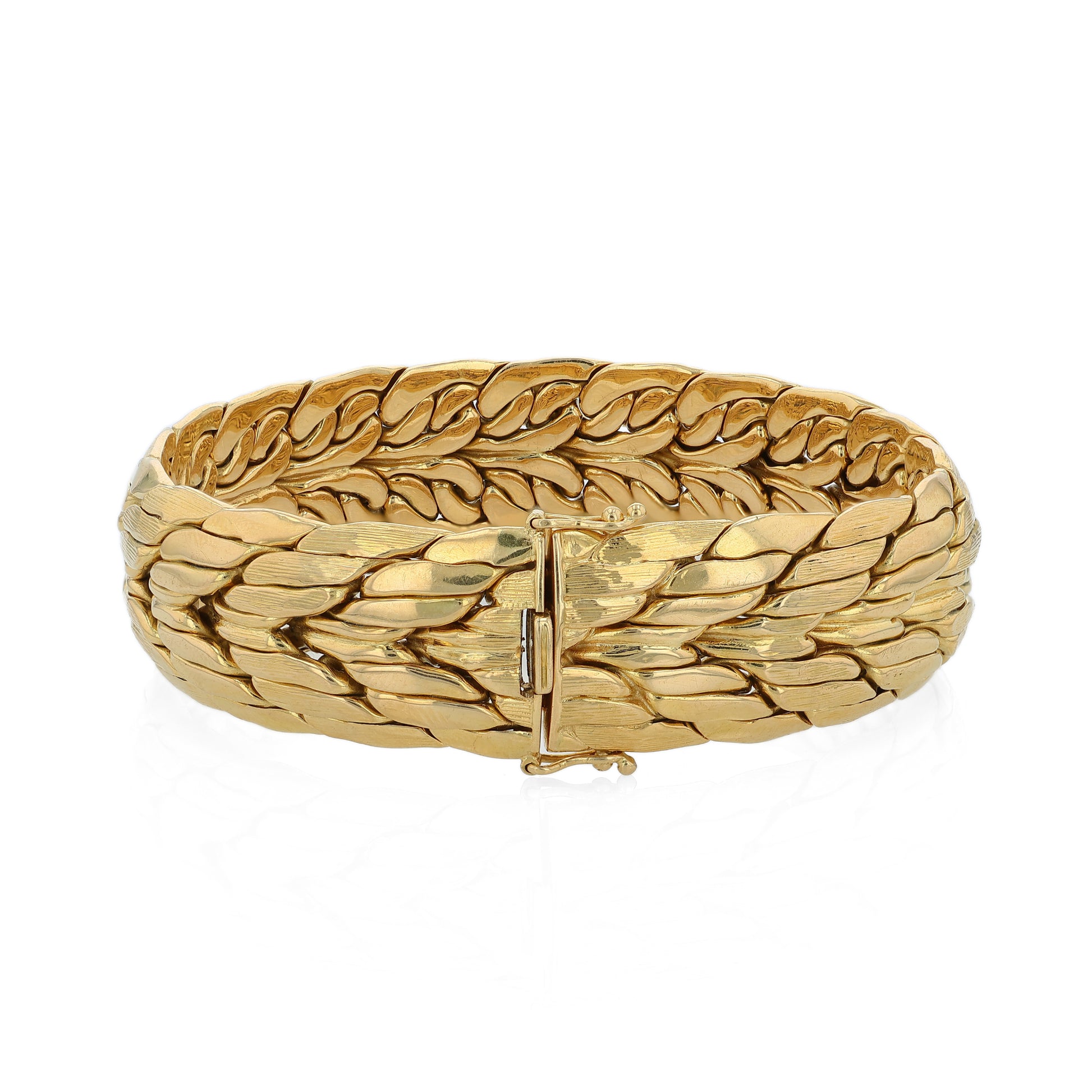 Brushed and polished yellow gold bracelet on a white background