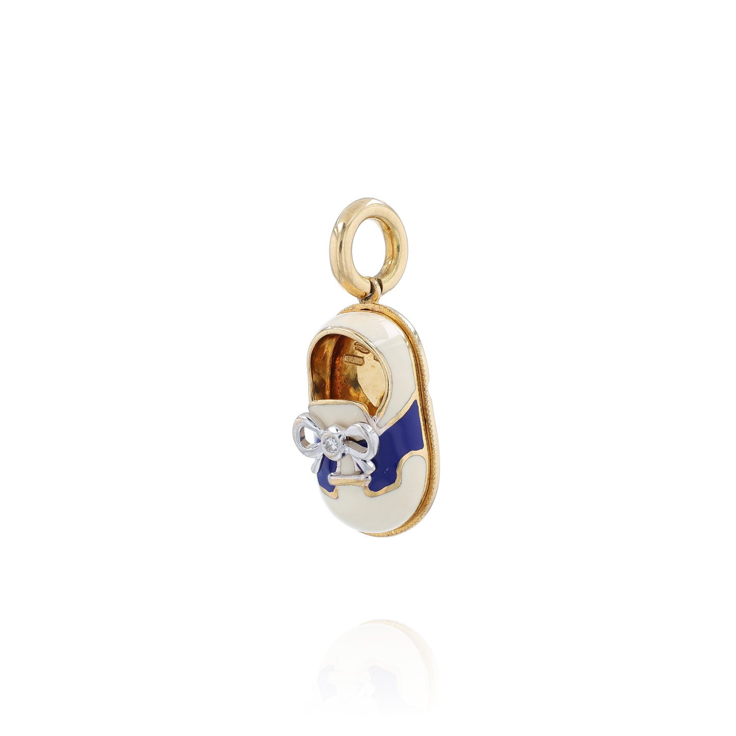 Yellow gold shoe charm pendant with  diamond on white gold bowtie on a white background