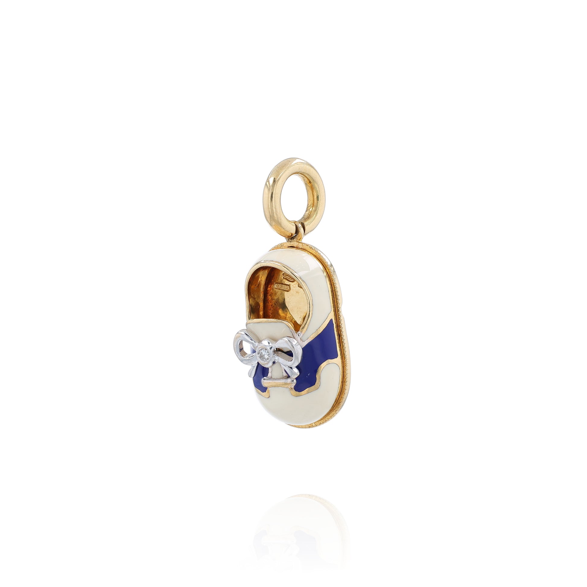 Yellow gold shoe charm pendant with  diamond on white gold bowtie on a white background