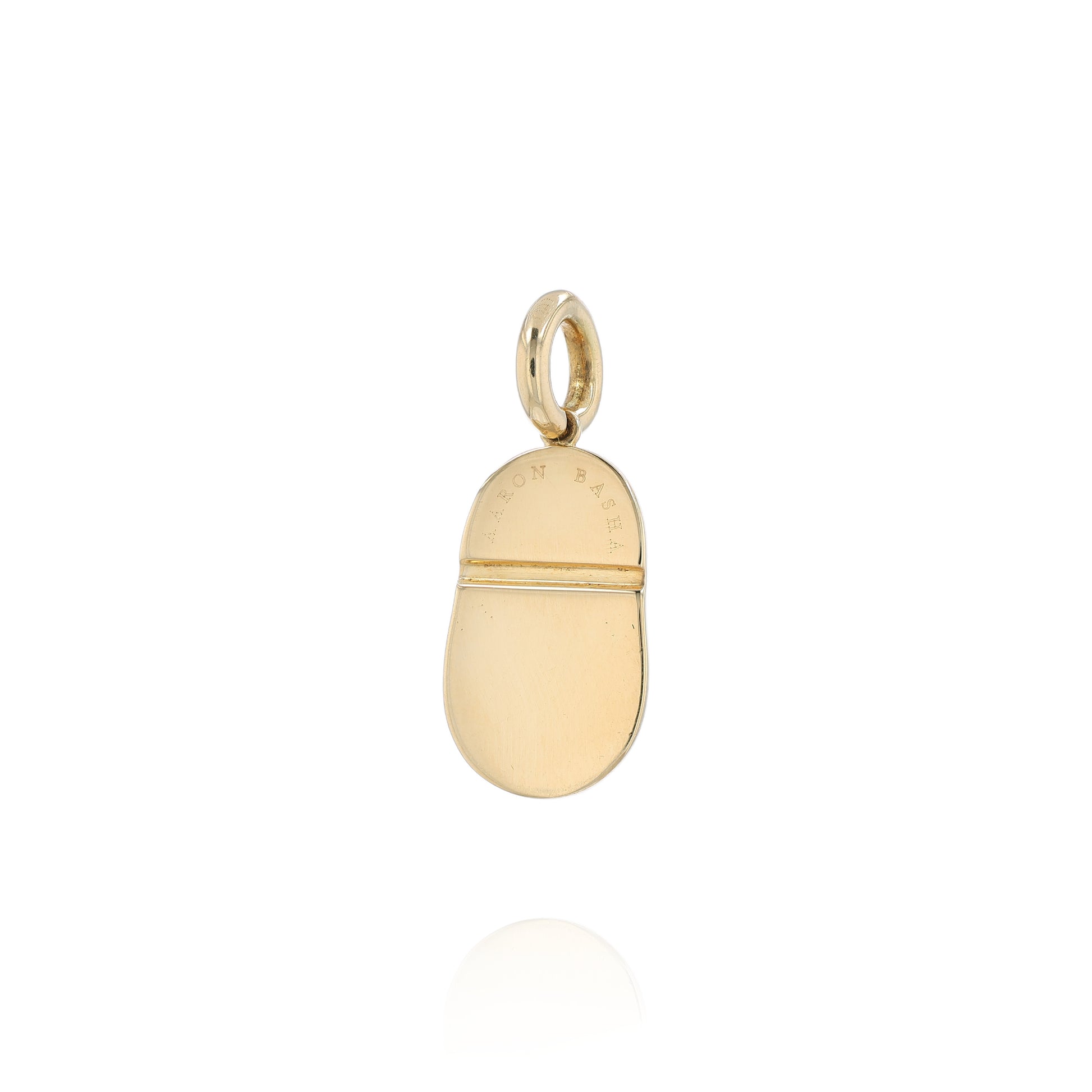 Yellow gold shoe charm pendant with  diamond on white gold bowtie on a white background