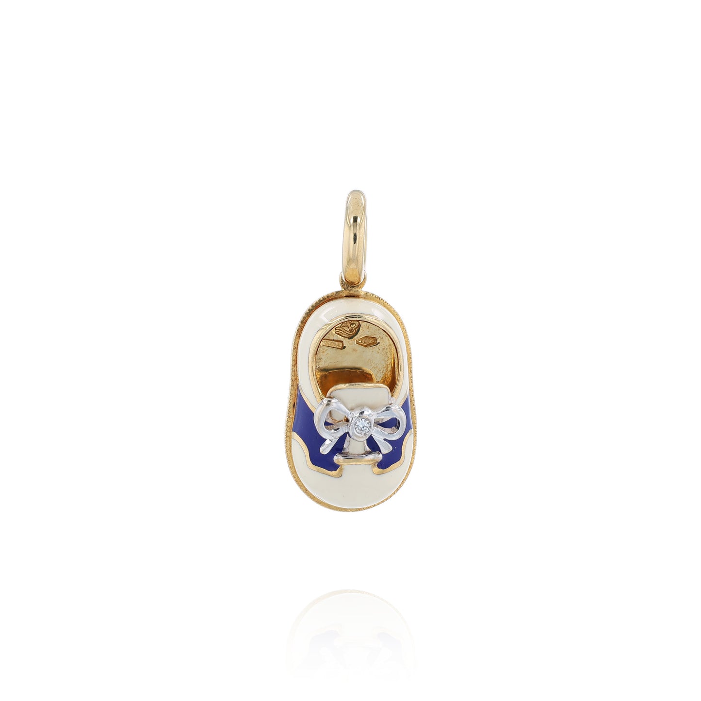 Yellow gold shoe charm pendant with  diamond on white gold bowtie on a white background