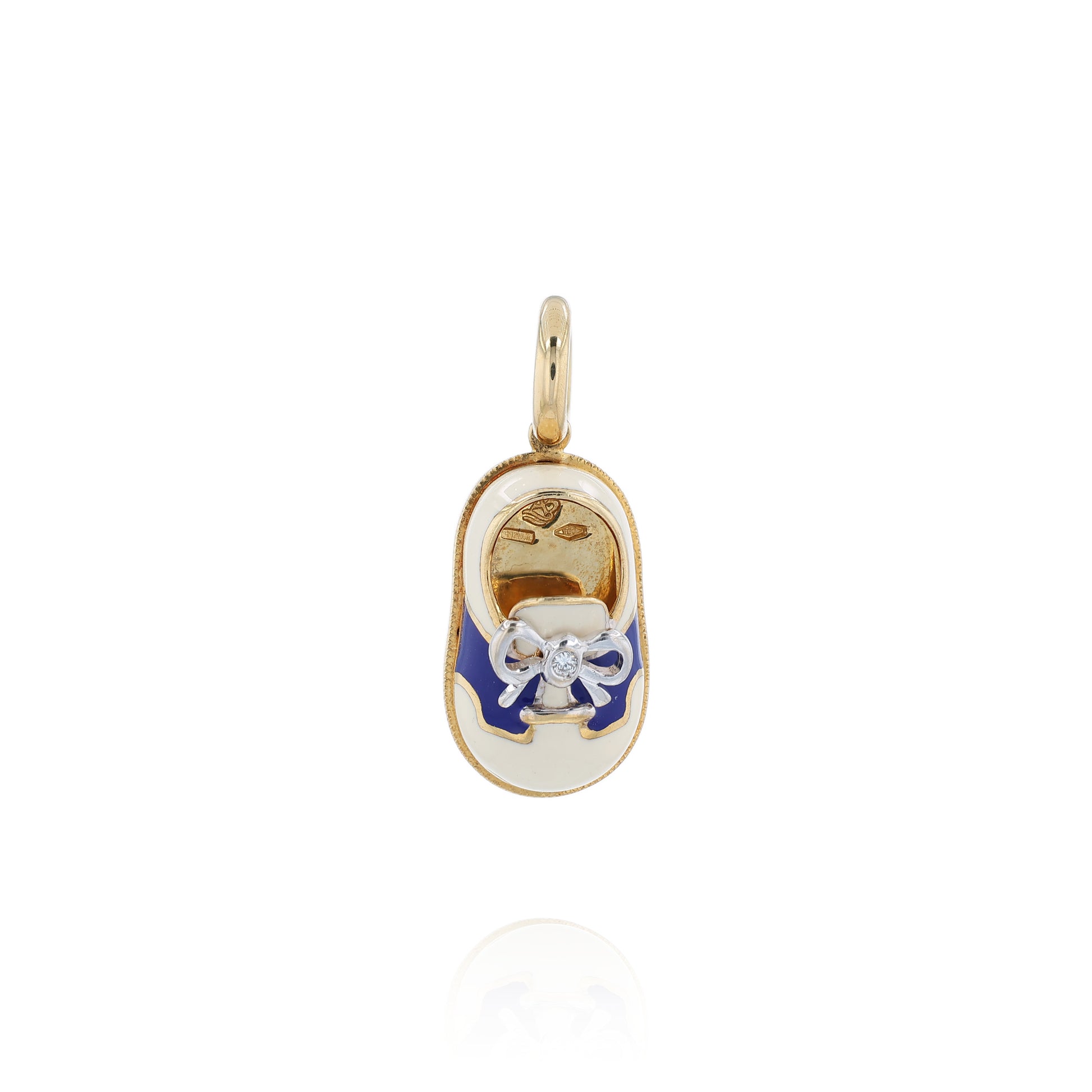 Yellow gold shoe charm pendant with  diamond on white gold bowtie on a white background