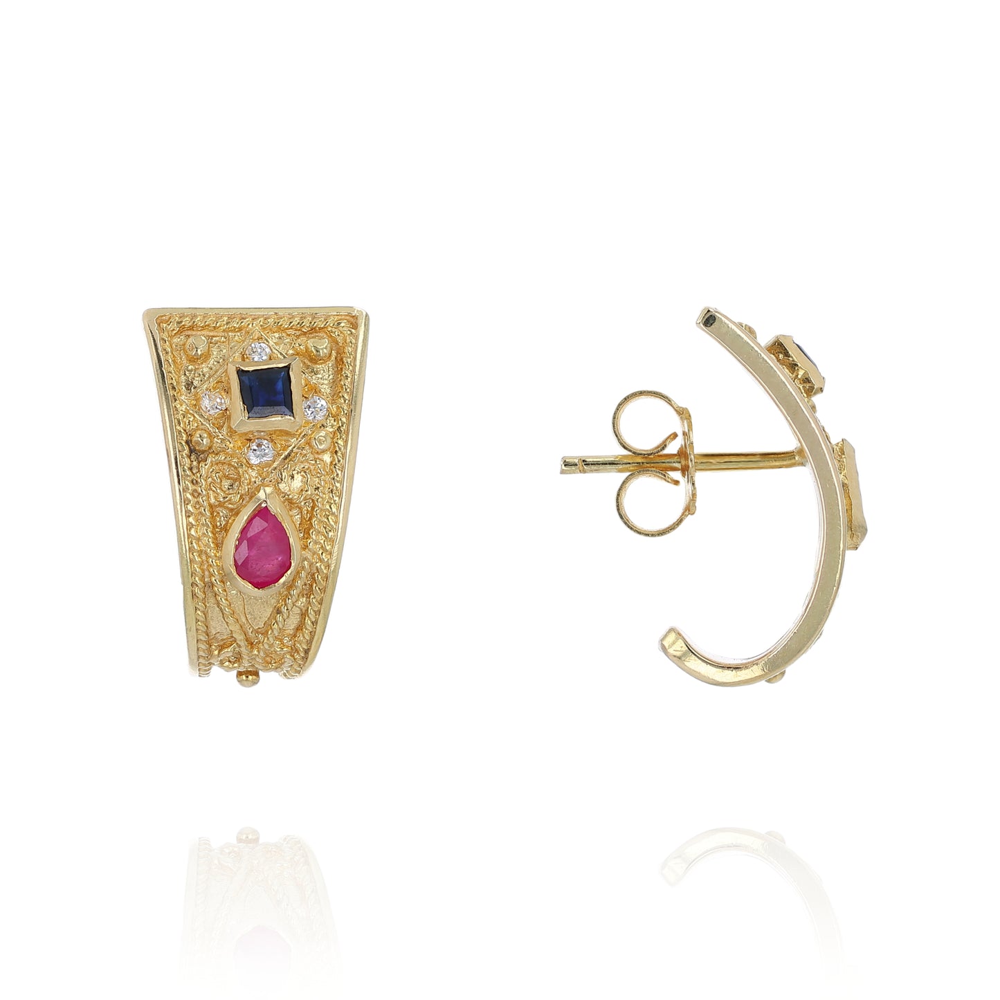 Gold earrings with rubies, sapphires, and diamonds on a white background