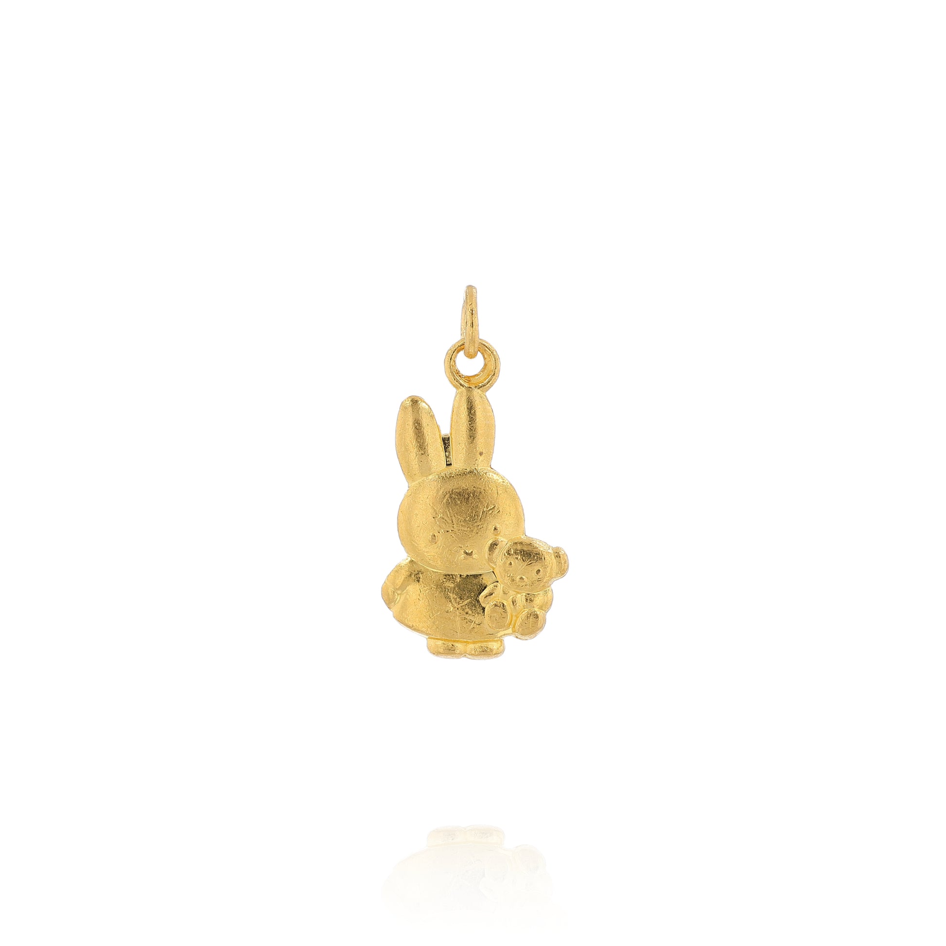 Yellow gold pendant depicting Miffy the Rabbit holding a stuffed animal bear on a white background