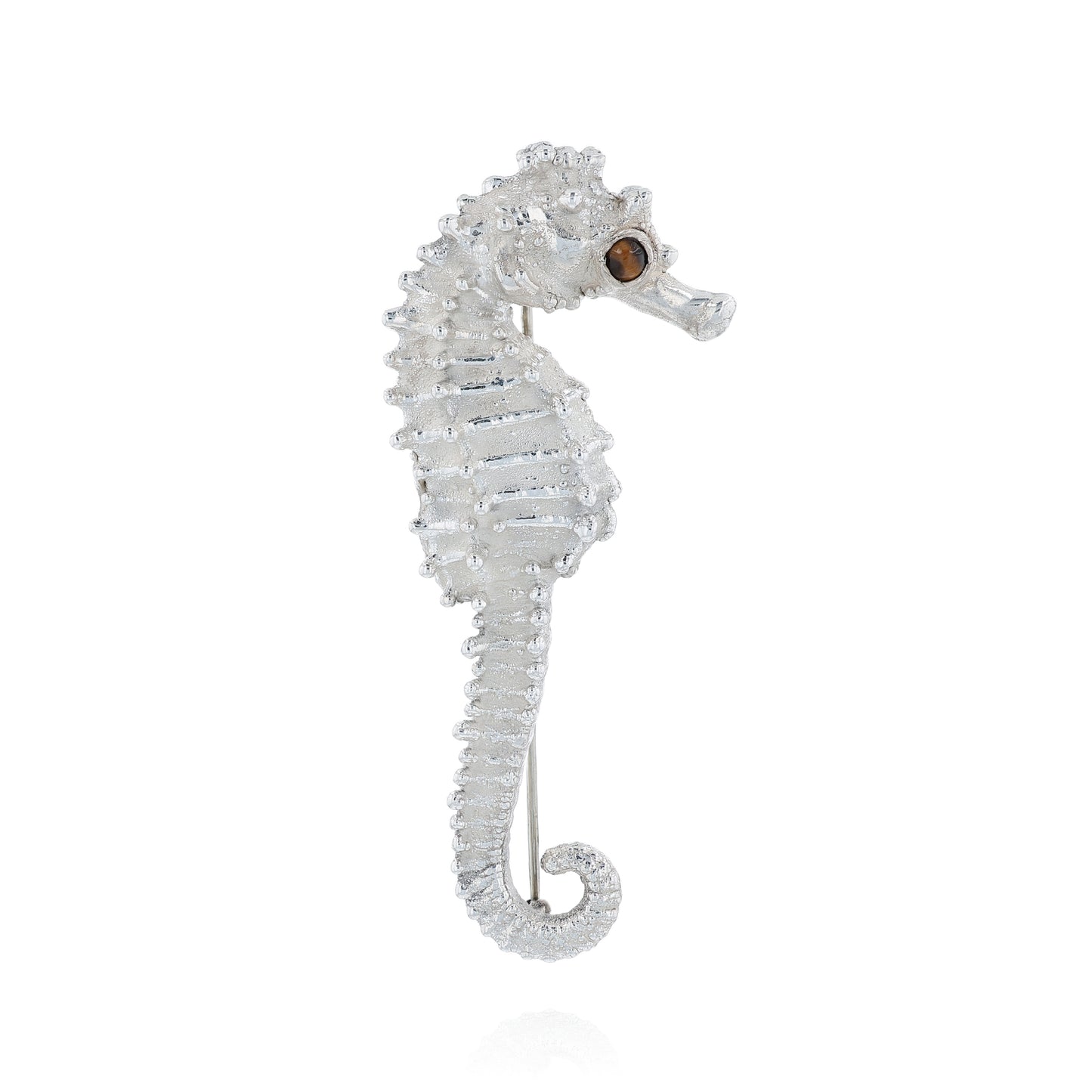 Sterling silver seahorse pin with a round tiger's eye in the eye on a white background
