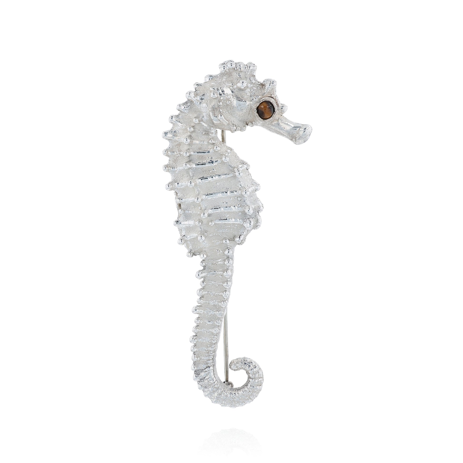 Sterling silver seahorse pin with a round tiger's eye in the eye on a white background