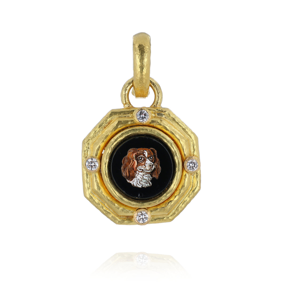 A gold pendant charm featuring a textured octagonal frame with four diamonds and a central black round inset displaying a mosaic portrait of a brown and white spaniel dog.