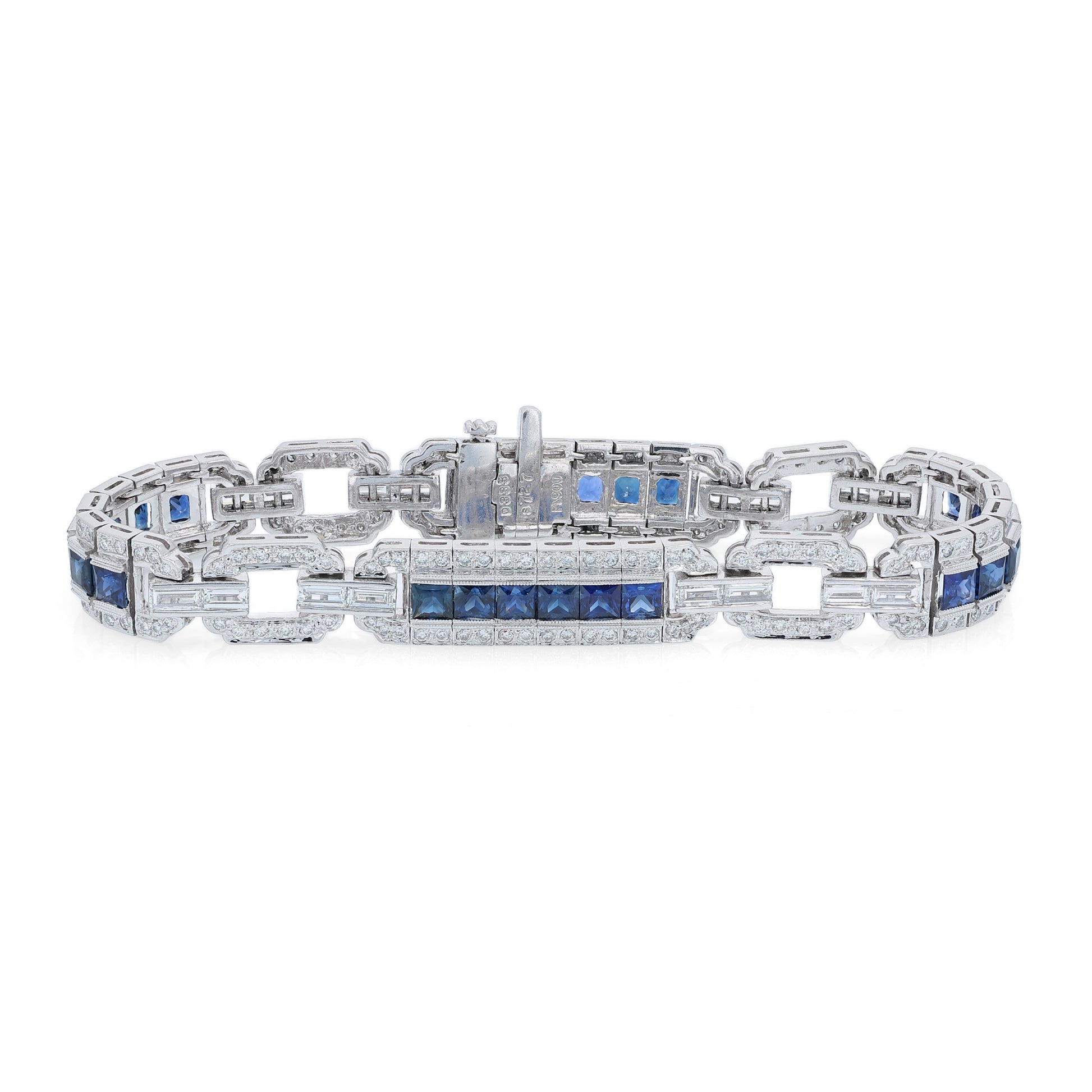 Platinum alternating synthetic sapphire and diamond link bracelet on a white background