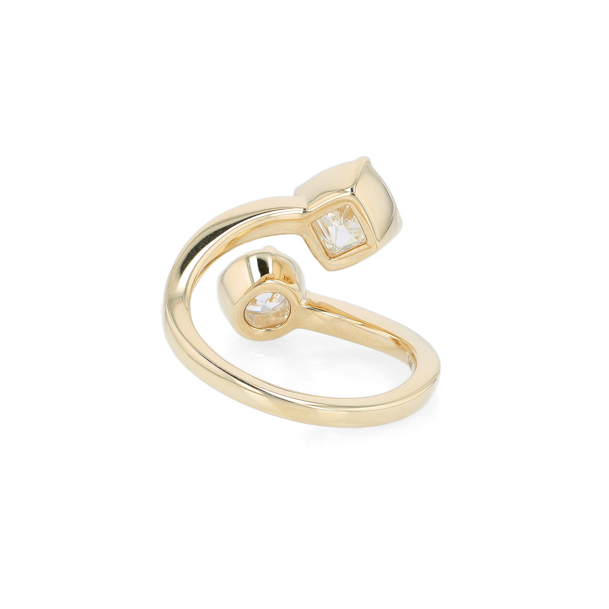 A yellow gold bypass ring featuring diamonds - a princess-cut and a round brilliant-cut diamond - on a clean white background.