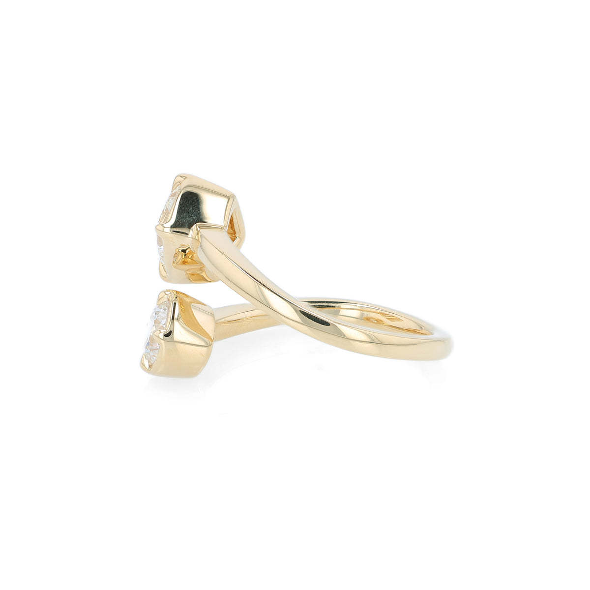 A yellow gold bypass ring featuring diamonds - a princess-cut and a round brilliant-cut diamond - on a clean white background.