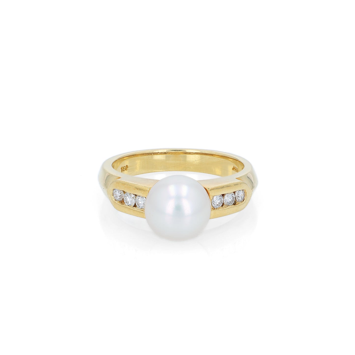 Yellow gold akoya pearl and diamond row ring on a white background