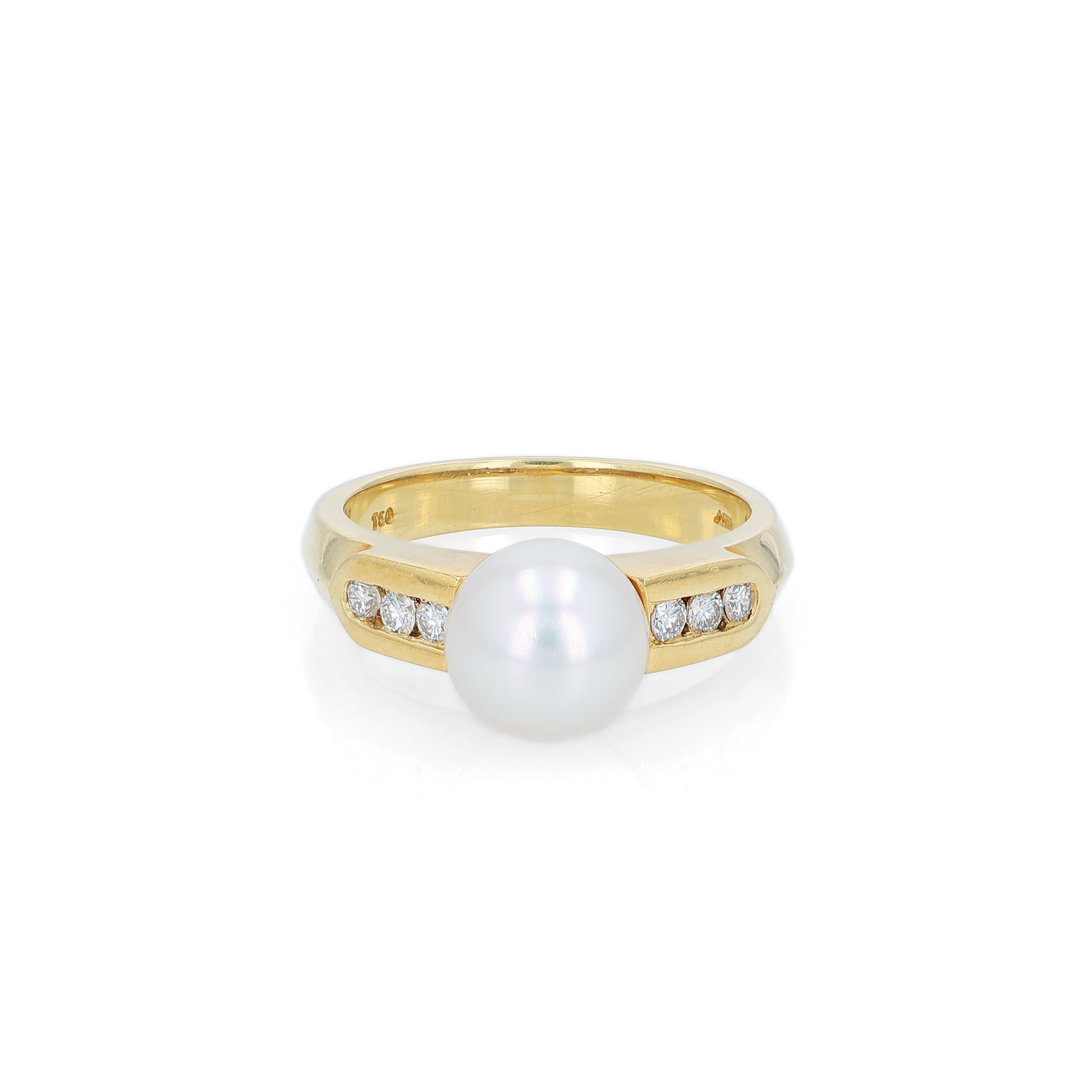 Yellow gold akoya pearl and diamond row ring on a white background
