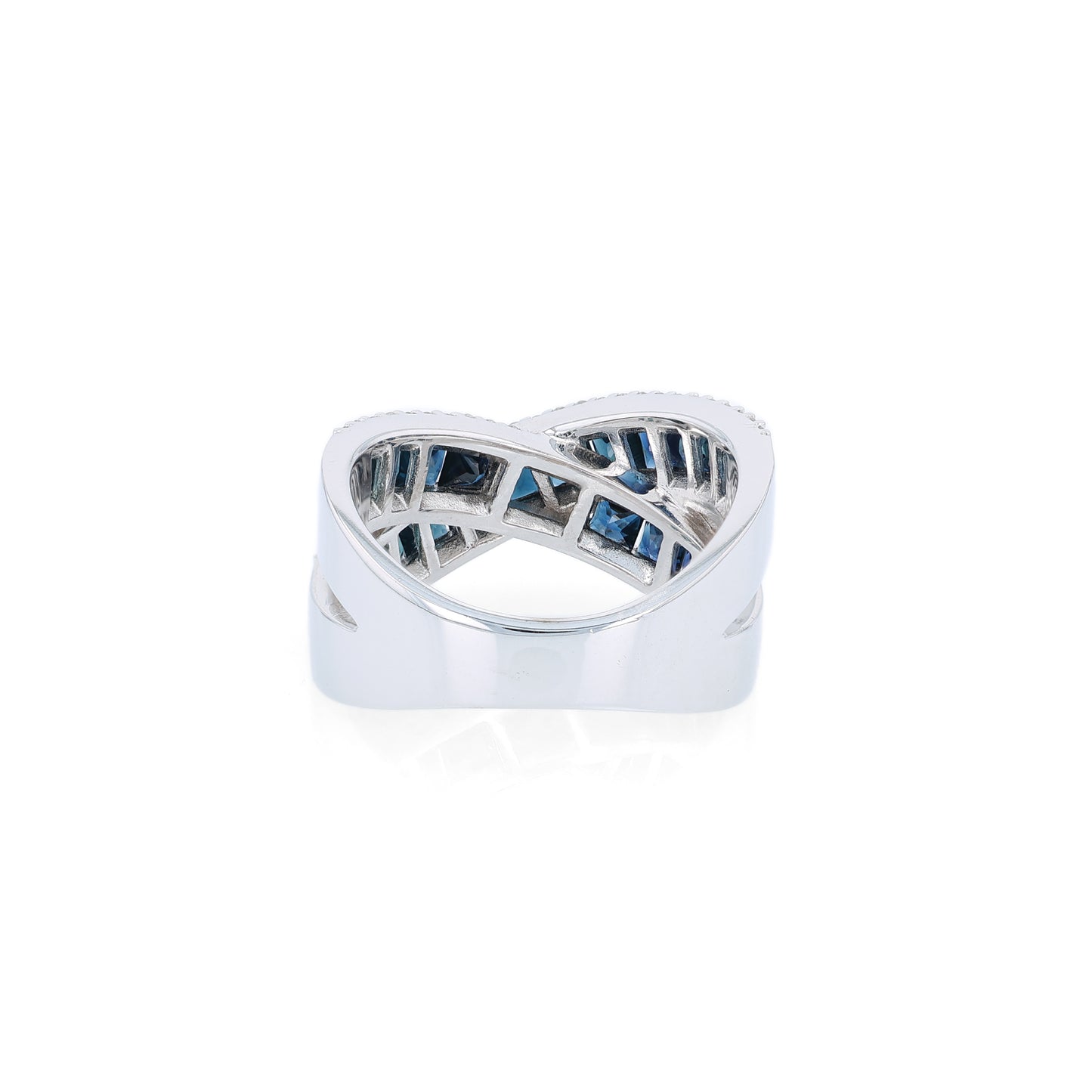 White gold crisscross design channel-set sapphire and diamond ring on a white background