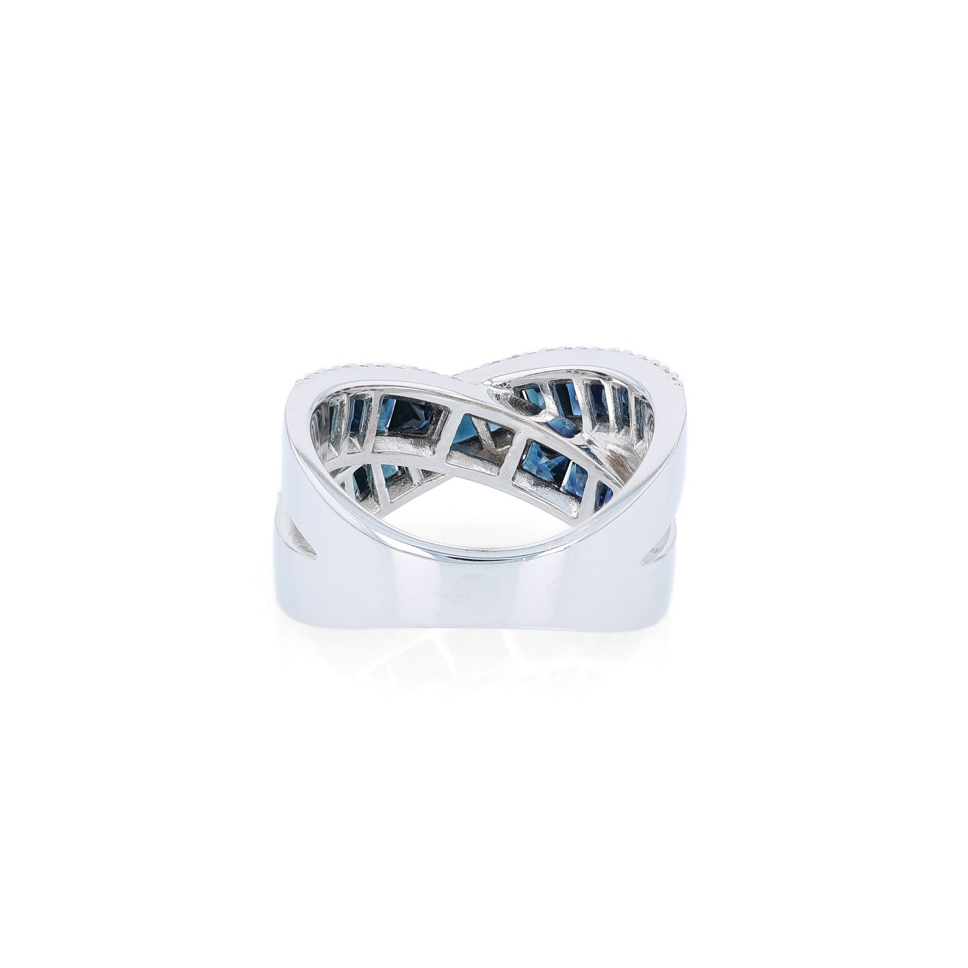 White gold crisscross design channel-set sapphire and diamond ring on a white background