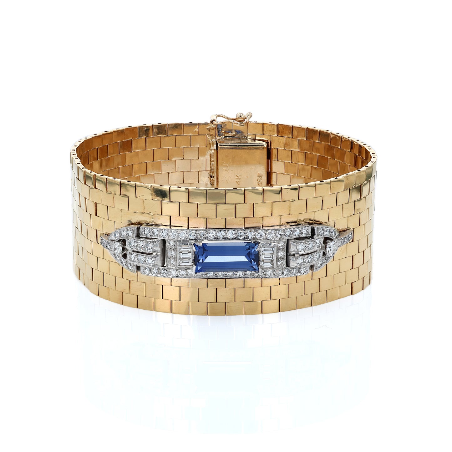 Yellow gold polished wide link design cuff bracelet with a diamond and synthetic sapphire center on a white background