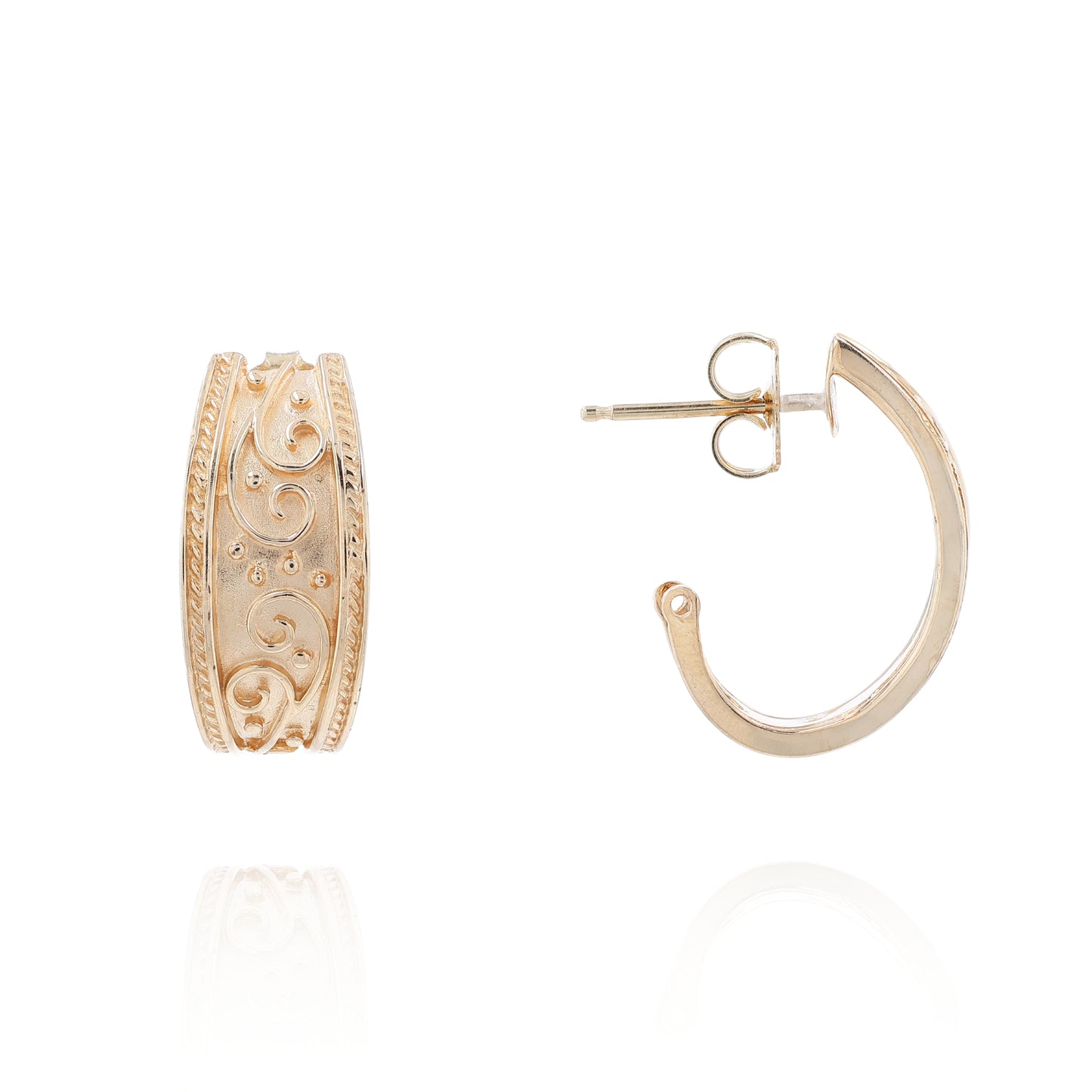 Yellow gold hoop earrings with an intricate scroll center design and a rope style border on a white background