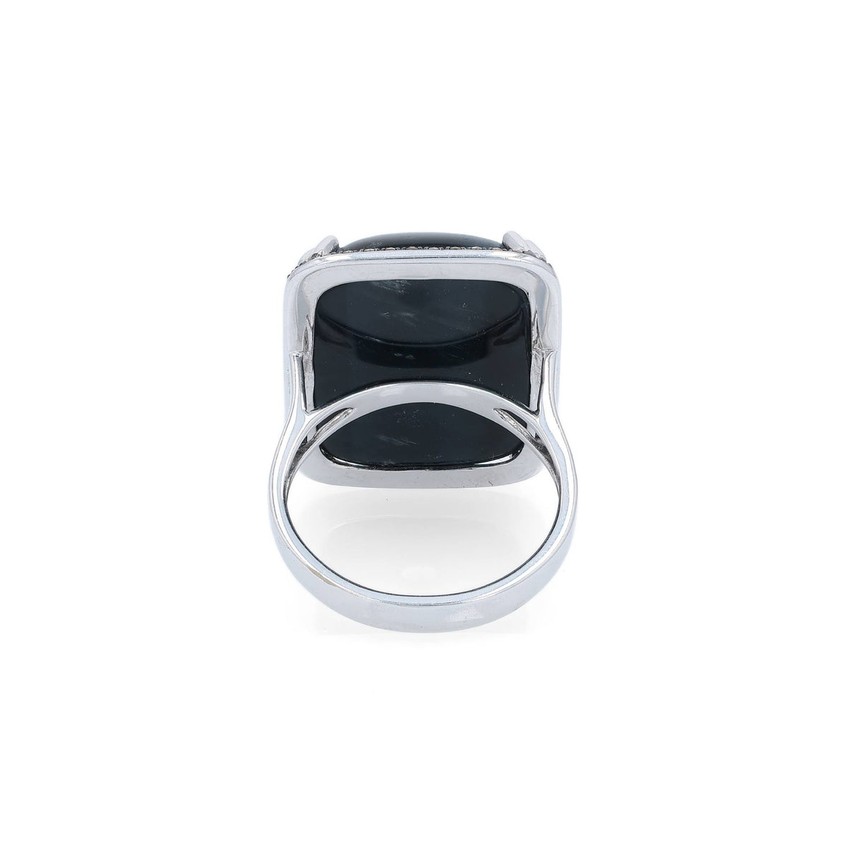 White gold ring with a rectangle cushion cabochon dyed blue cat's eye and a brown single cut diamond halo on a white background