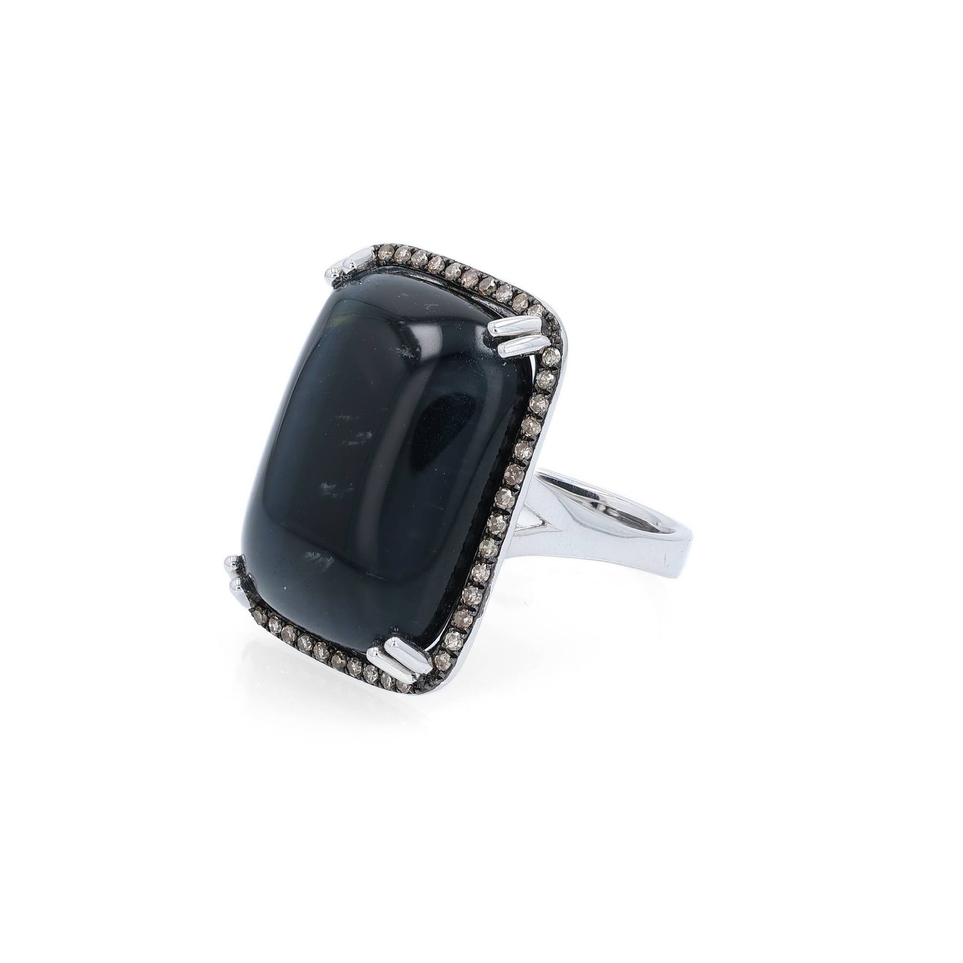 White gold ring with a rectangle cushion cabochon dyed blue cat's eye and a brown single cut diamond halo on a white background
