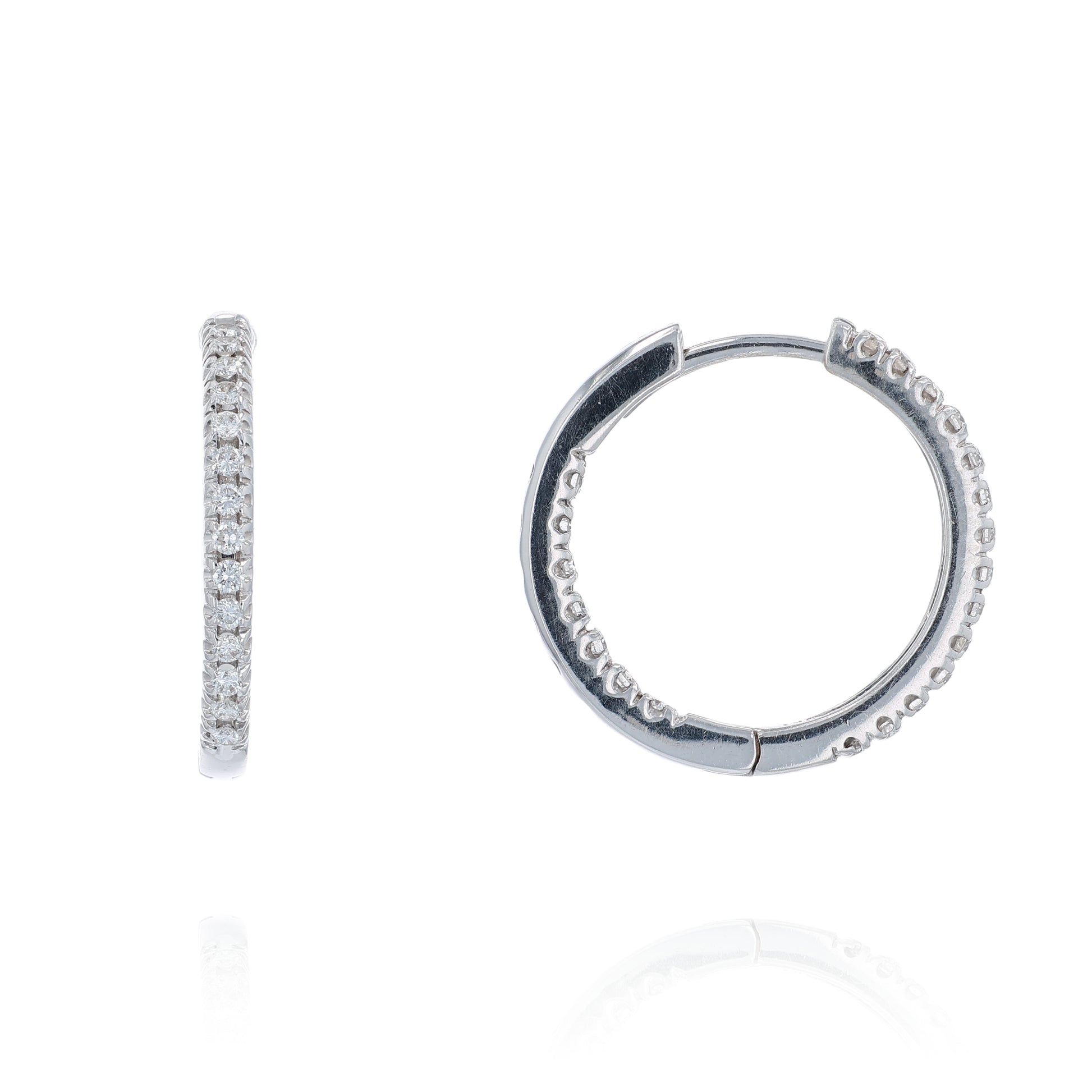 White gold diamond in and out hoop earrings on a white background