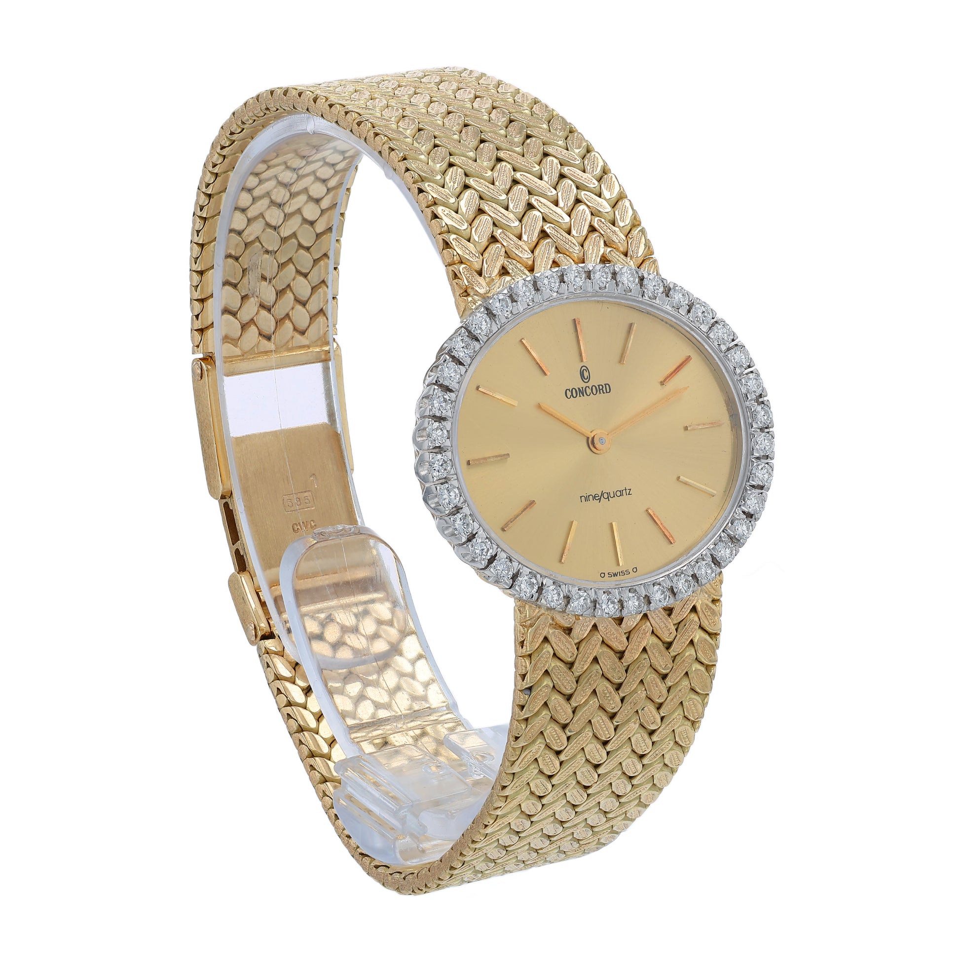 Angle of a gold Concord watch with a diamond bezel and a champagne dial on a white background