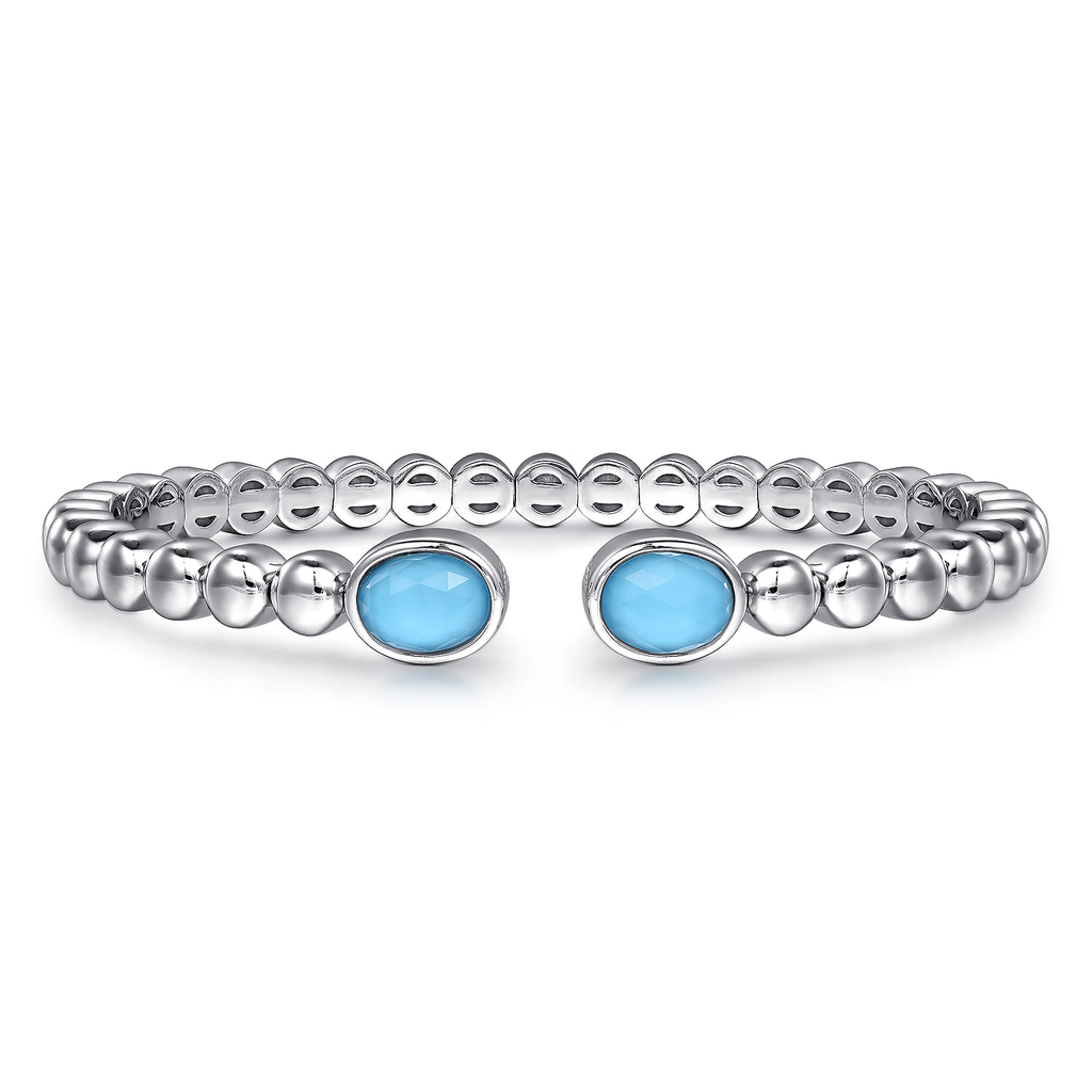 Silver bracelet with blue gemstones on a white background
