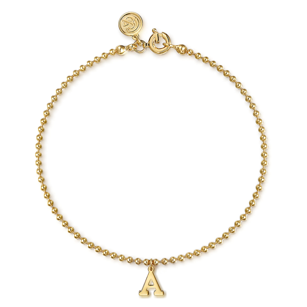 gold beaded bracelet with initial A drop on white background