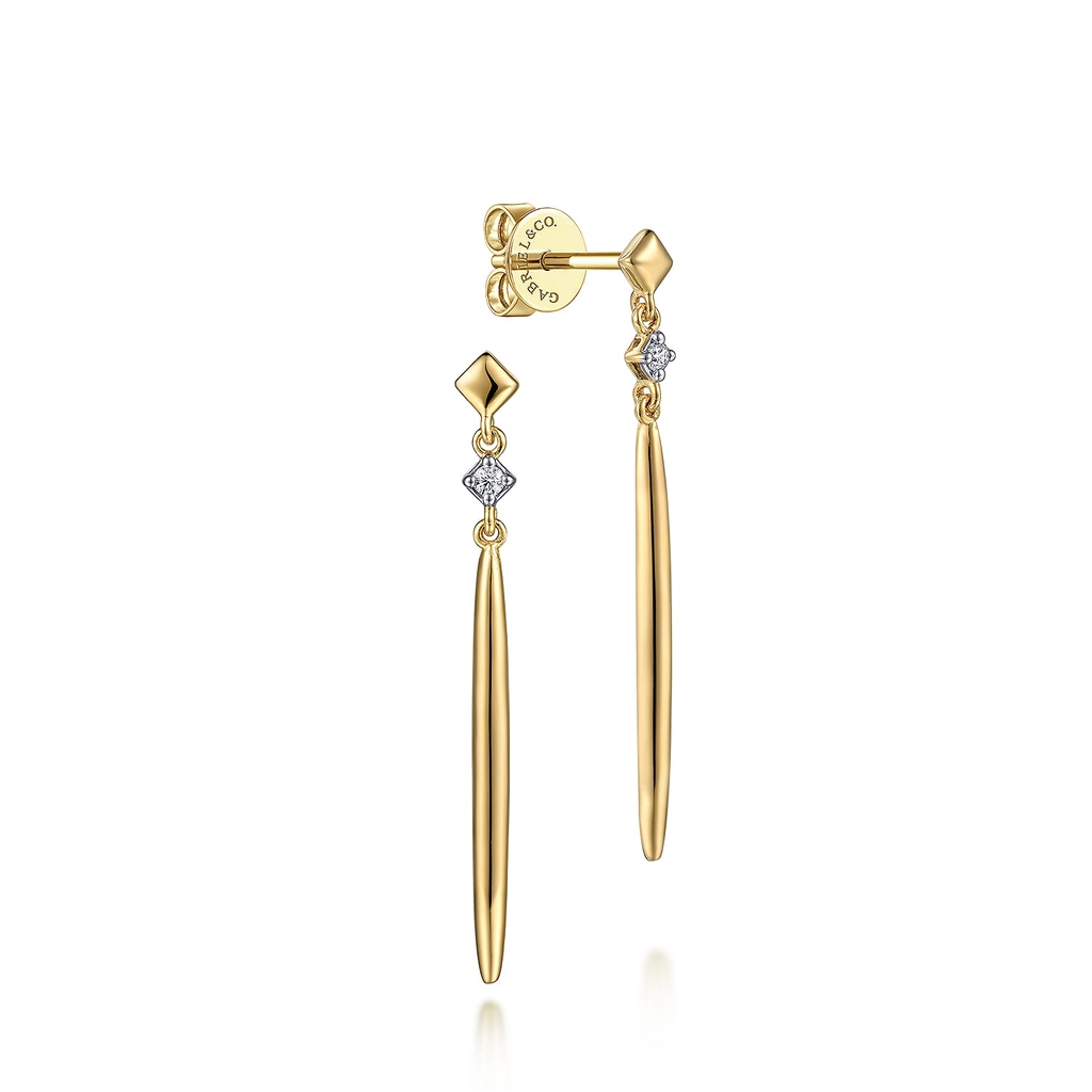 Gold earrings with diamond accents on a white background