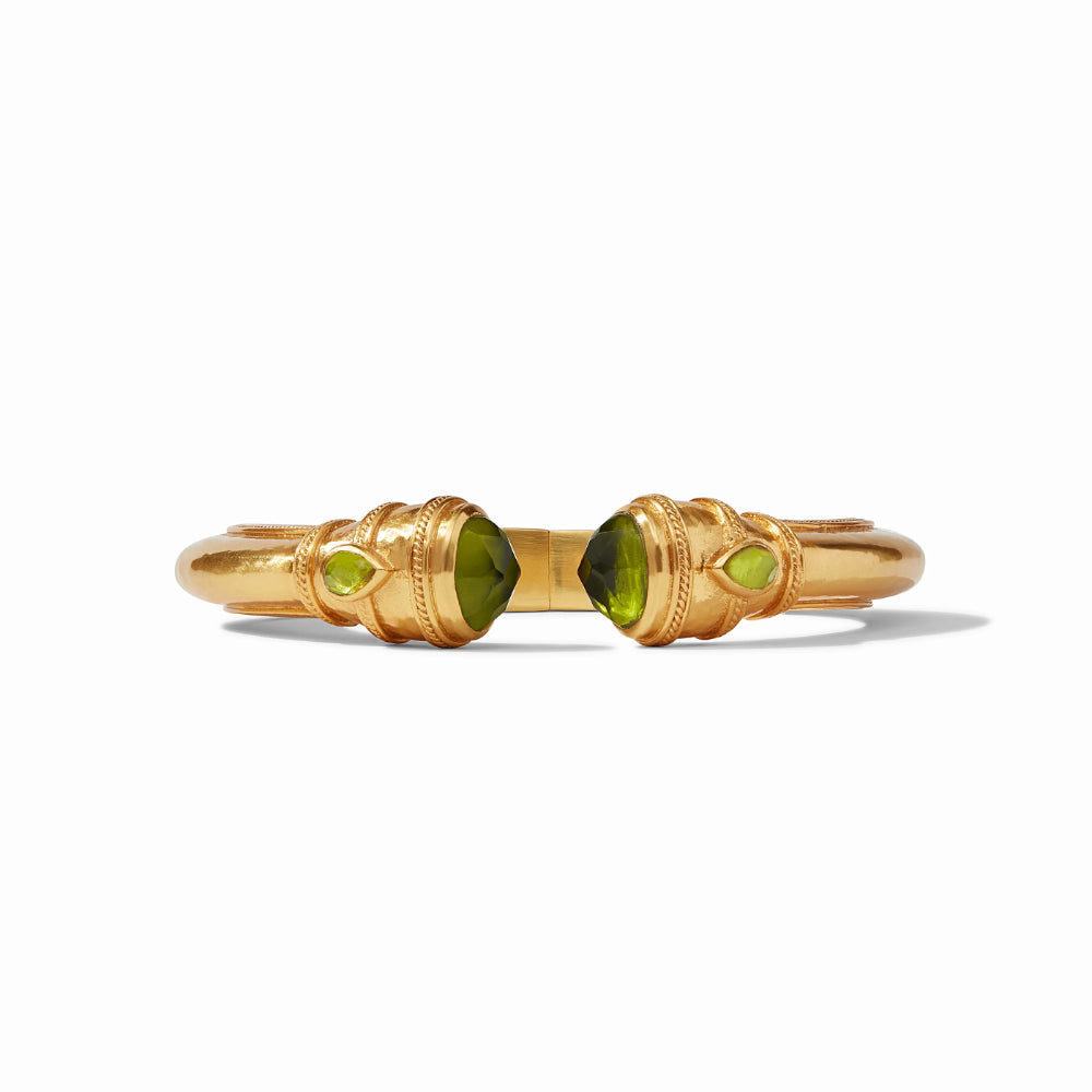 Gold bracelet with green gemstones on a white background