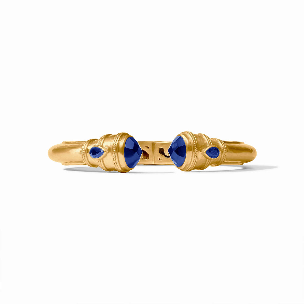 Gold bracelet with blue stones on a white background