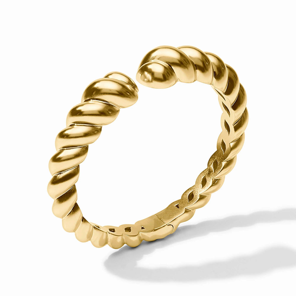 Gold ring with braided design on a white background