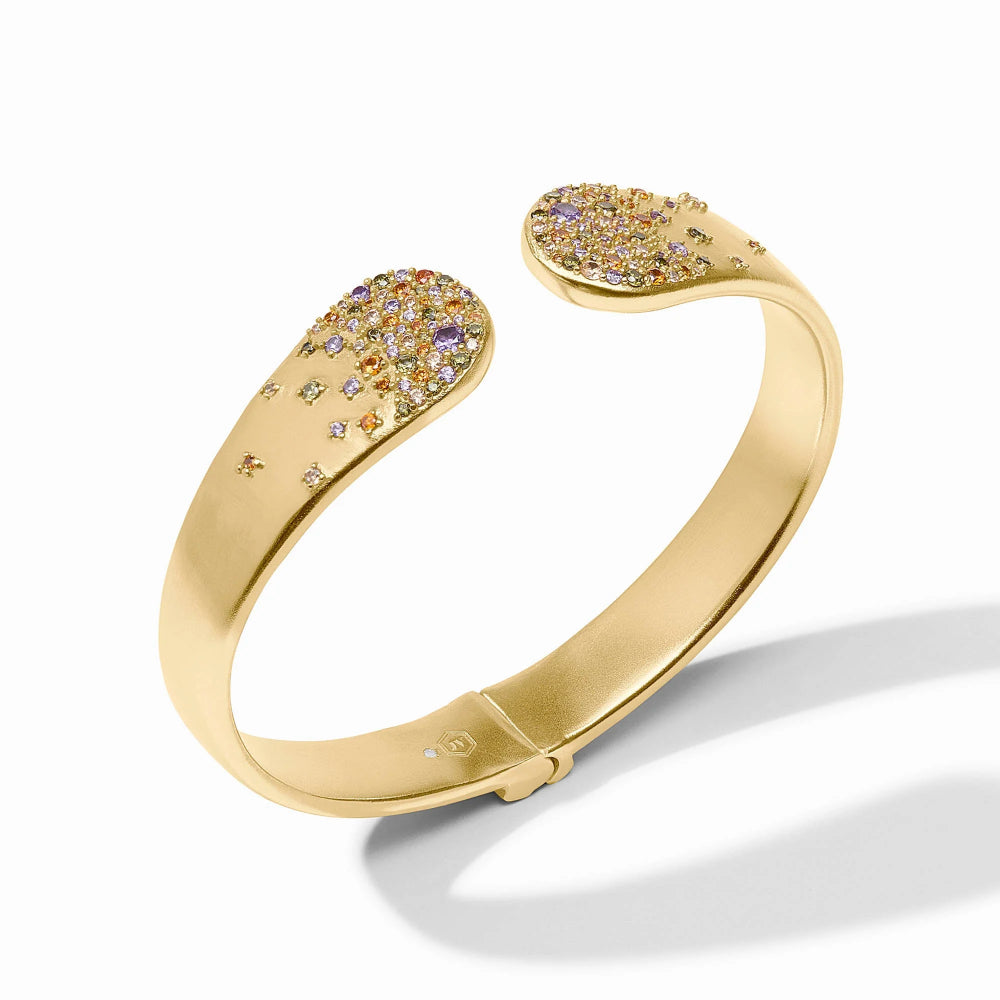 A polished yellow gold cuff bracelet with two rounded, open ends decorated with pavé-set gemstones in yellow, orange, and purple tones, shown on a clean white background with a soft shadow.
