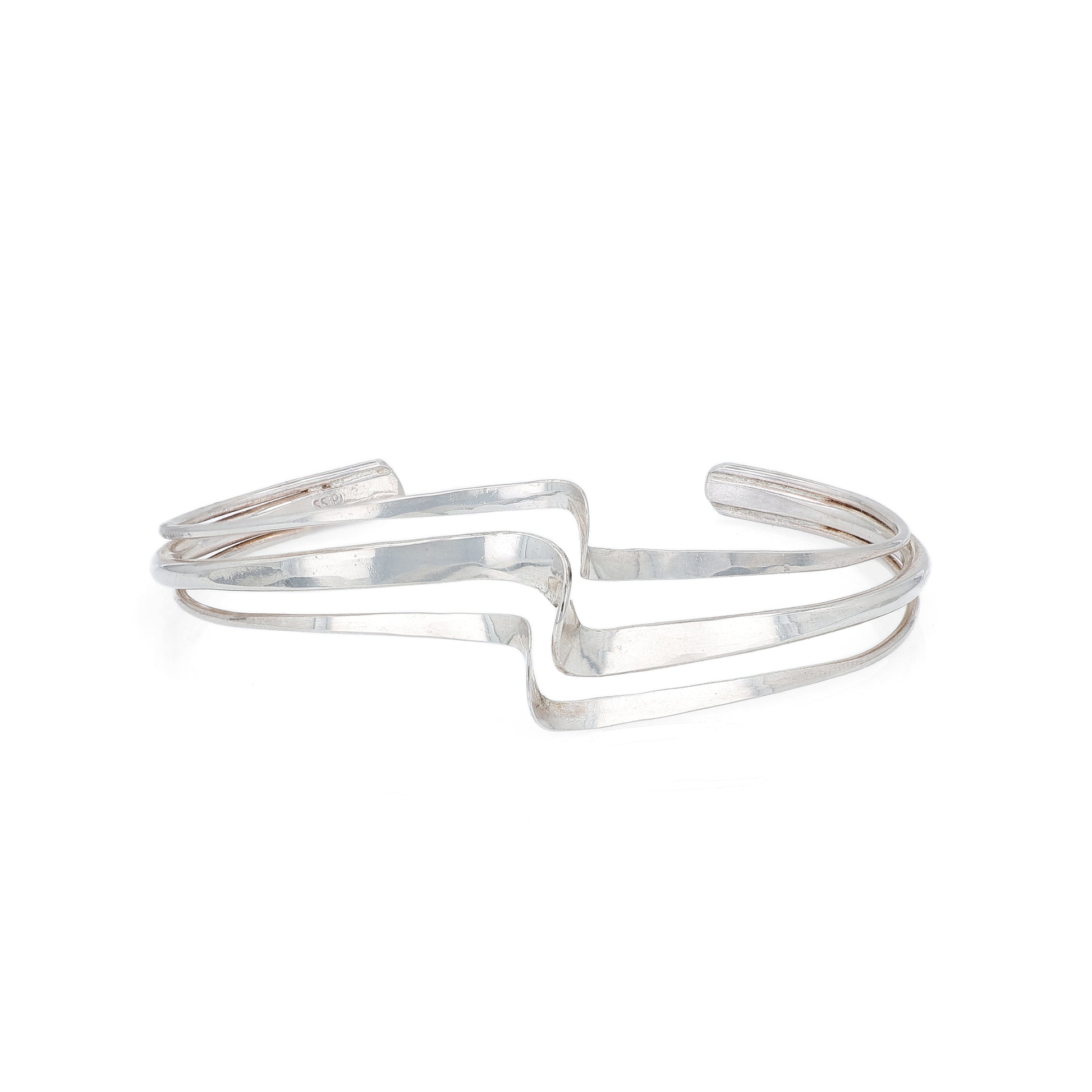 Silver polished wave design triple row bracelet on a white background