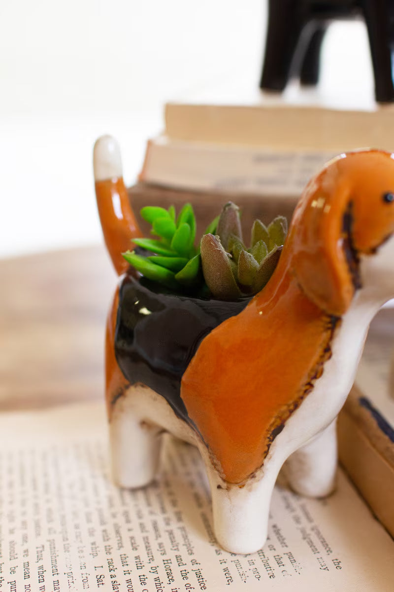 Dog-shaped planter with succulents on a surface