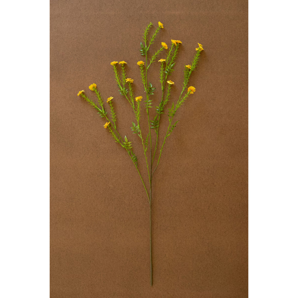 Artificial flower branch with yellow flowers on a brown background