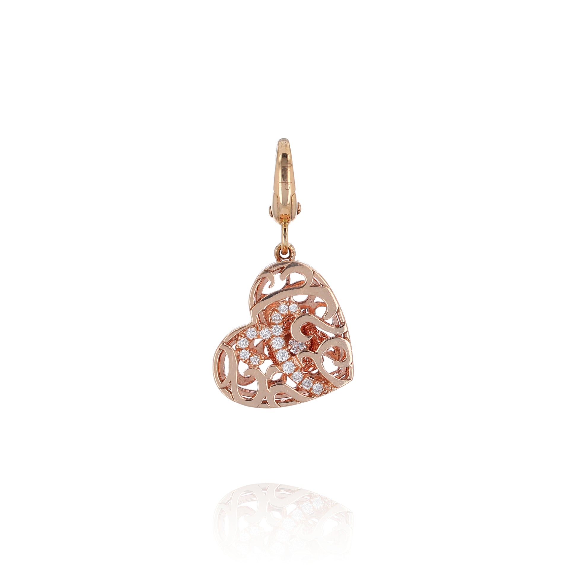 Rose gold filigree design diamond heart charm pendant on a white background