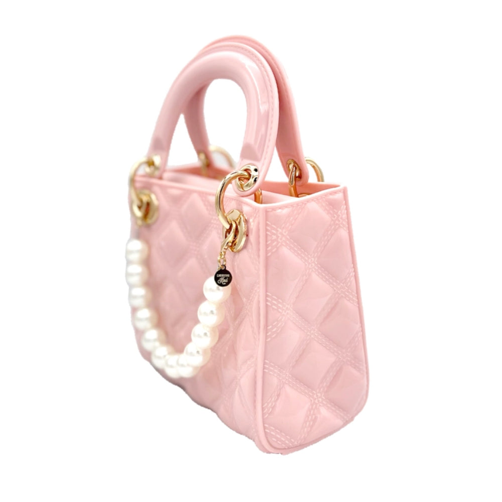 A quilted ballet pink handbag with a matching cross-body strap and attached white pearls