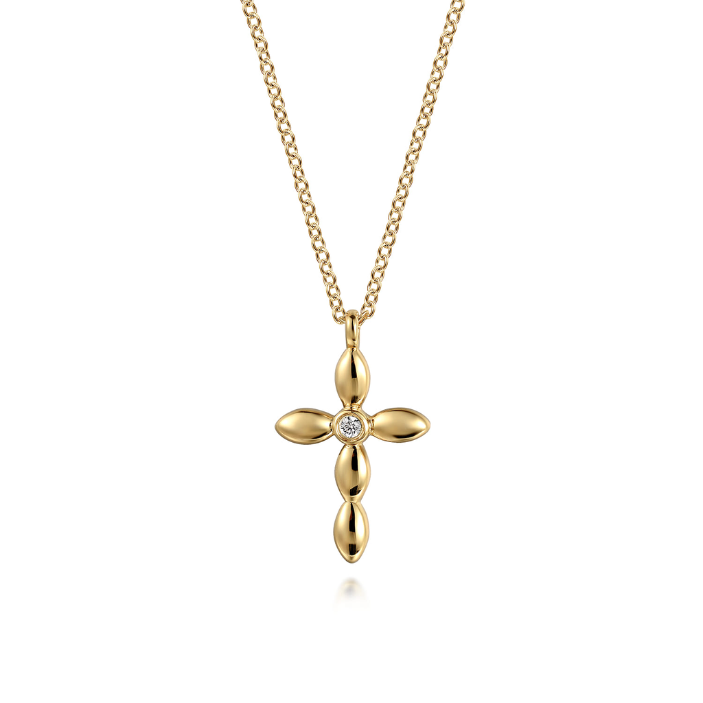 yellow gold cross pendant necklace on white background