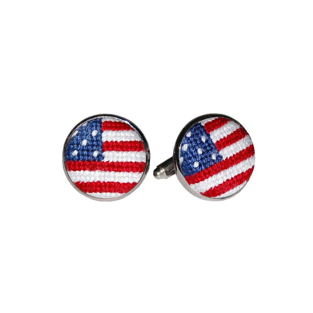 Pair of needlepoint american flag cufflinks on a white background