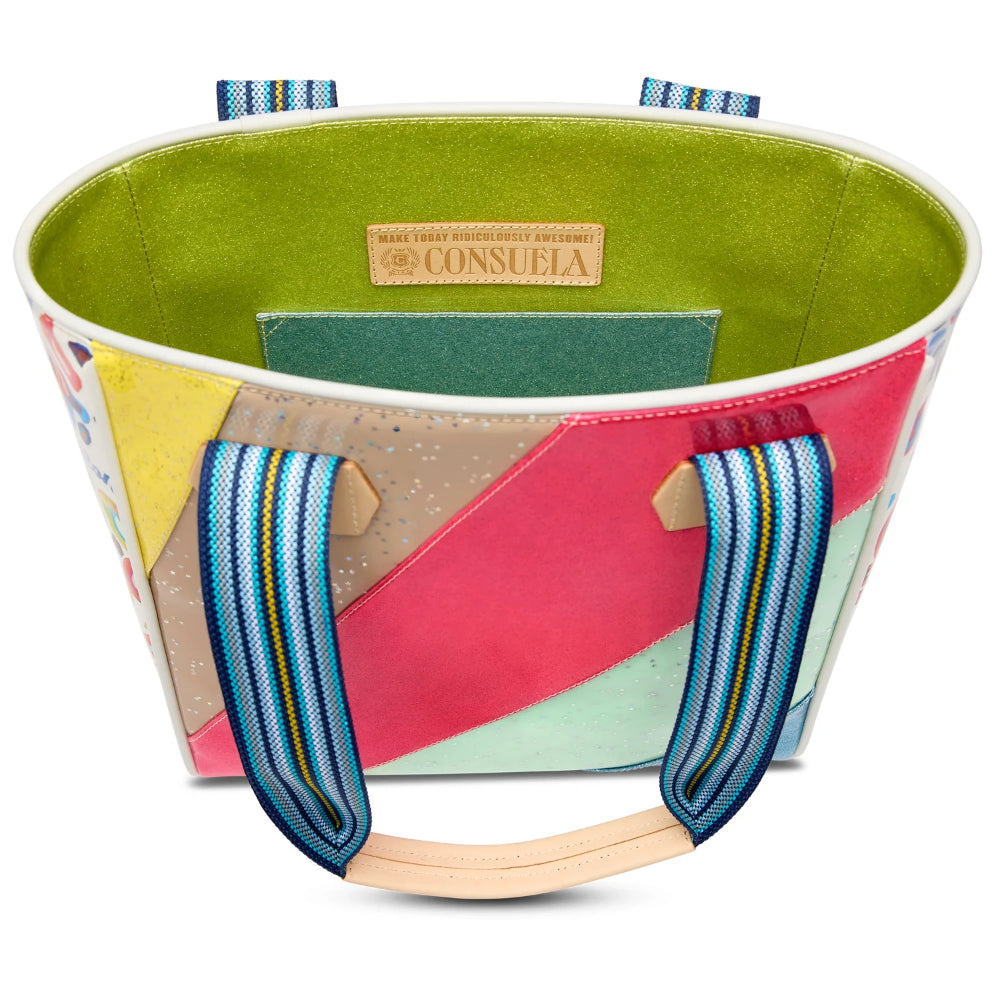 Colorful fabric basket with geometric pattern and blue handles on a white background