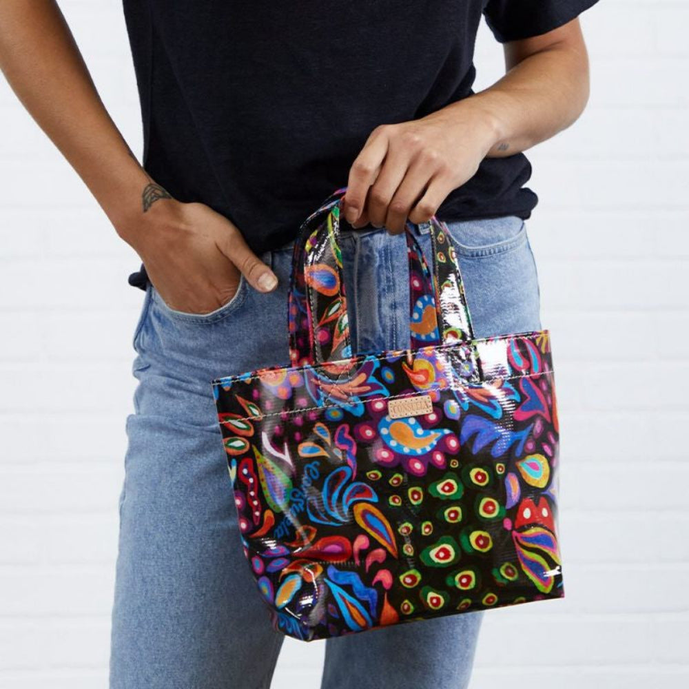 Person displaying A multicolored floral tote bag with a ConsuelaCloth exterior.