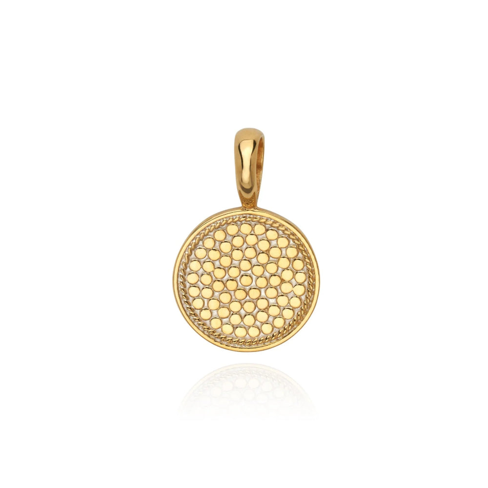 Texture round gold pendant on a white background.