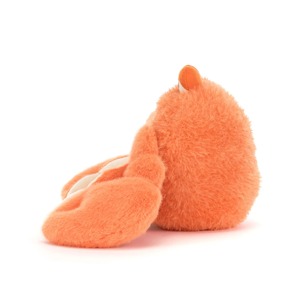 Side photo of an orange pinchsnap crab plush toy on a white backround