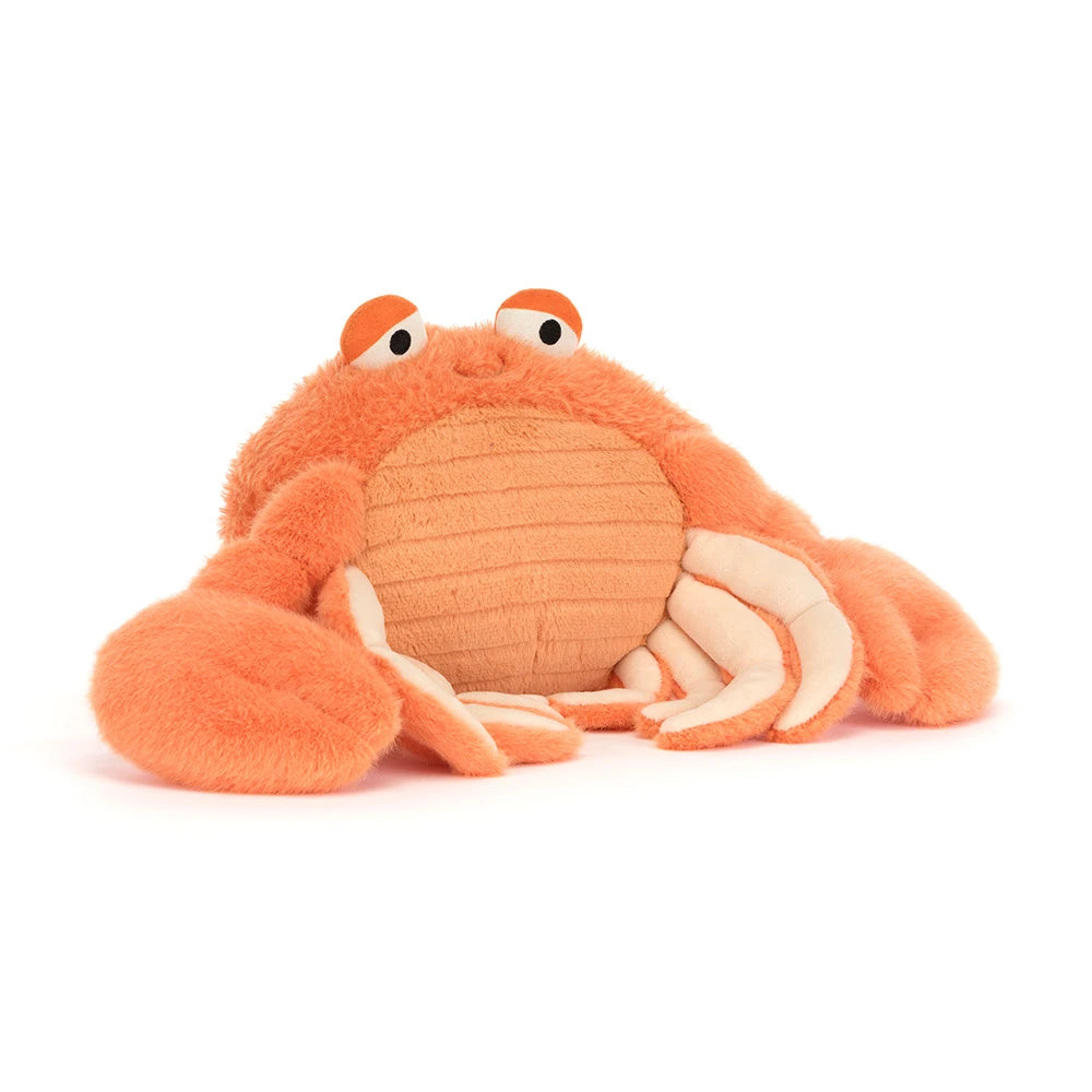 Angled side photo of an orange pinchsnap crab plush toy on a white backround 
