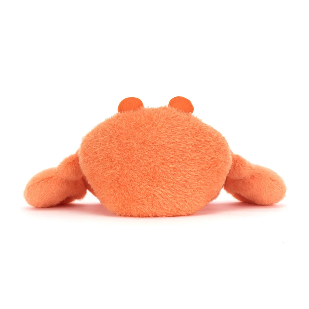 A photo of the back of an orange pinchsnap crab plush toy  on a white backround 