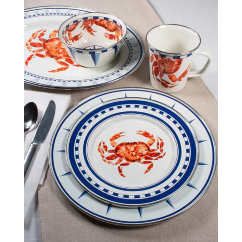 Dinnerware set with crab design on a beige tablecloth