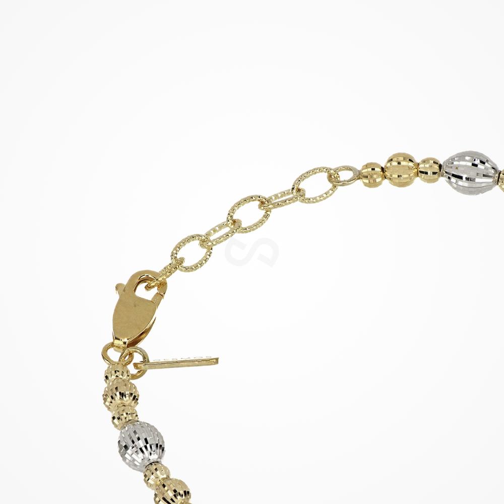 Gold and silver beaded bracelet on a white background