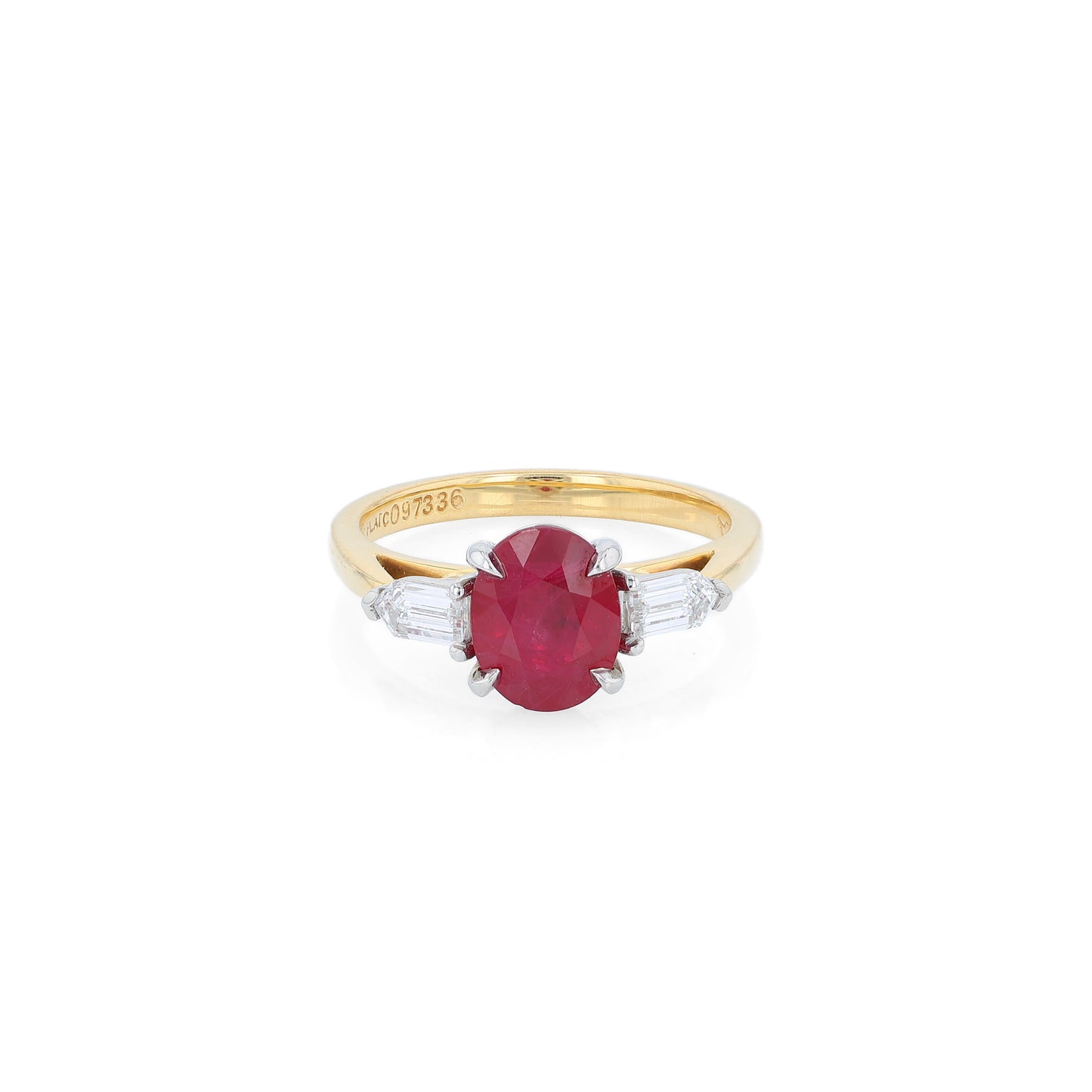 Gold ring with a ruby center and diamond sides on a white background