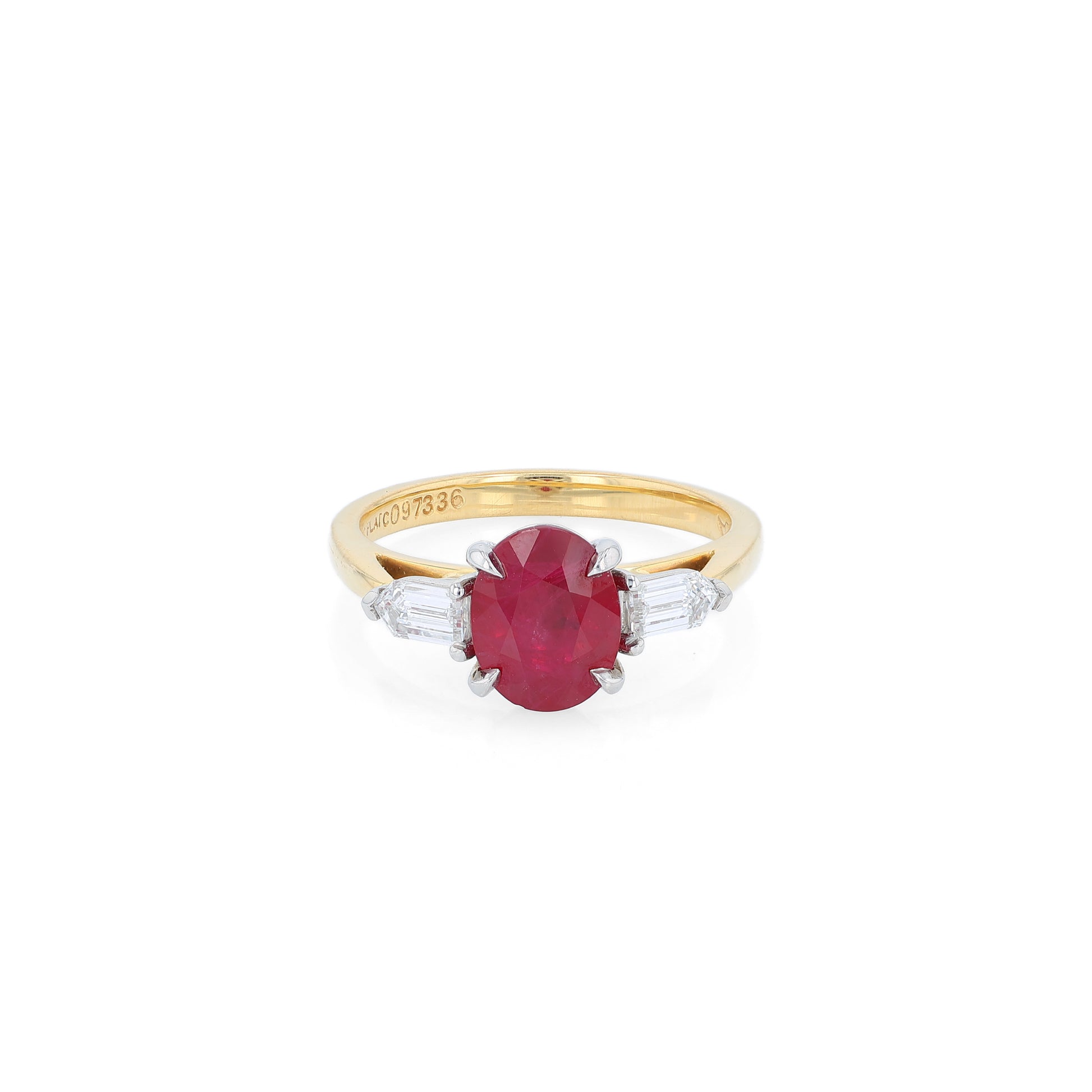 Gold ring with a ruby center and diamond sides on a white background